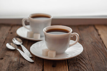 Fototapeta na wymiar Coffee on a wooden table in white mugs