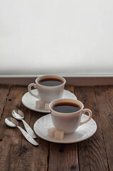 Coffee on a wooden table in white mugs