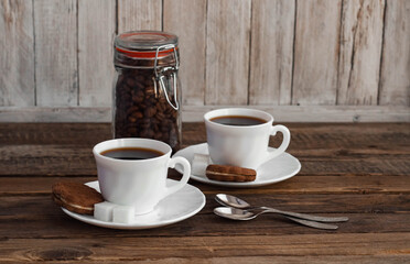 Coffee on a wooden table in white mugs