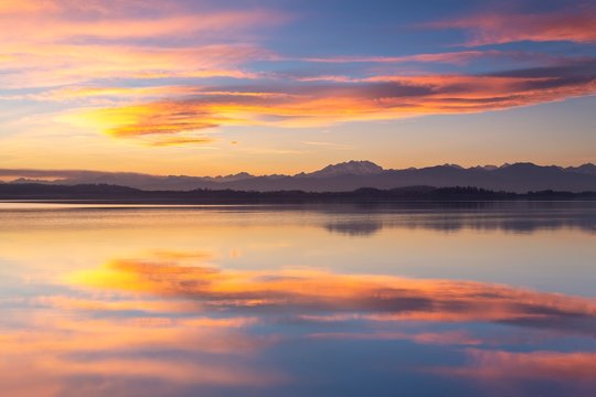 Monte Rosa reflecting on Lake Varese during a winter sunset at Calcinate del Pesce, Varese Province, Lombardy, Italy.