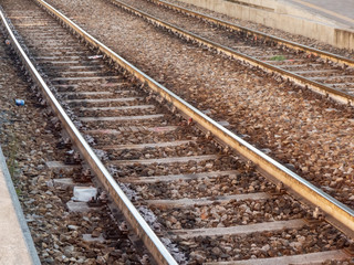 Fototapeta premium perspective of railroad tracks at sunset