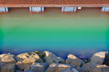 Wooden dock, rainbow river and sandy rocks