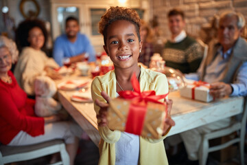  Cute African girl giving Christmas present