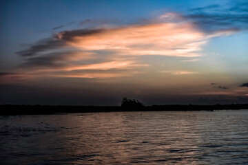 sunrise over lake wiith clouds
