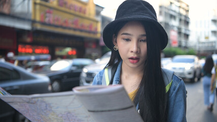 Travel concept. Beautiful girls are reading the map on the roadside. 4k Resolution.