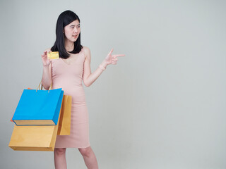 Woman holding shopping bag and credit cards