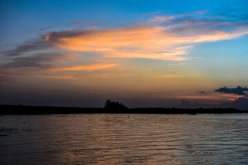 sunrise over lake with clouds