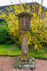 Beautiful old weathered Station of the Cross, Church of St. Lambert in Manderfeld, Liege Province, Buellingen Municipality, Belgium churchyard