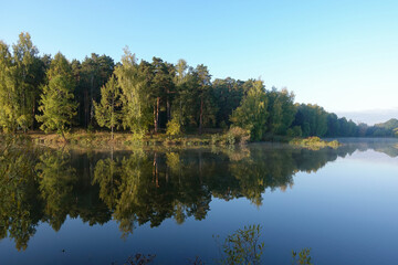 Fototapeta na wymiar Ideal landscape. Autumn day. Lake in the forest.