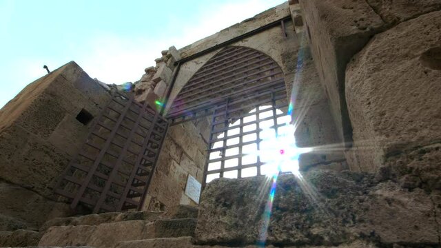 Sun shines behind a window of Sidon Sea Castle in Sidon, Lebanon
