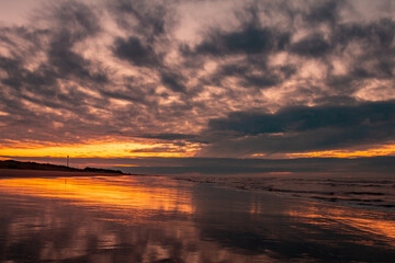 Fototapeta na wymiar Beautiful and romantic sunset on the sea coast. Deserted beach paradise. Fall of the sun.