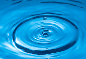 Naklejka na ściany i meble water drop and water splash, blue water surface