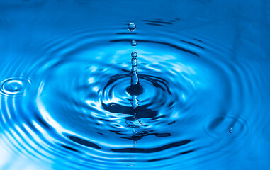 Naklejka na ściany i meble water drop and water splash, blue water surface