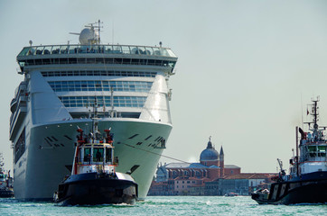 Modern white cruise ship Costa Victoria with tug boats and pilot in Giudecca Canal Grande with...