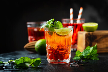 Red fresh cocktail with ice and lime