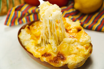 Stretch cheese on bake potatoes au gratin