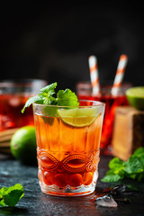 Red fresh cocktail with ice and lime