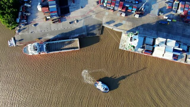 Container ship and supply tug alongside at port Degrad des Cannes.