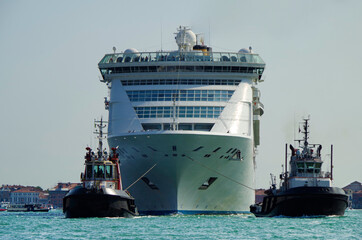 Modern white cruise ship Costa Victoria with tug boats and pilot in Giudecca Canal Grande with...
