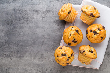 Homemade chocolate muffins on the vintage background.