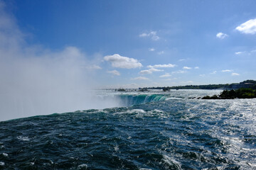 Magnificent Niagara Falls as seen near the main waterfall ledge showing the large rampant of mist produced.