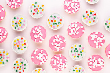 Colorful cupcakes on a white background.