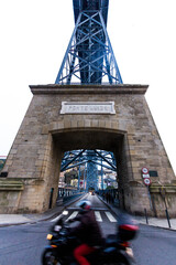 Symmetrical view of famous bridge with moving biker in the center