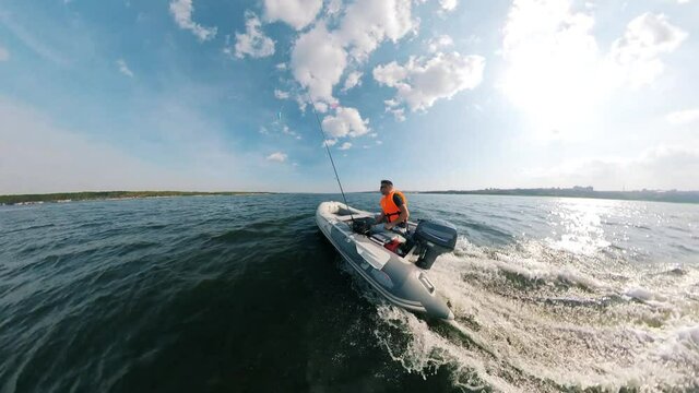 Floating inflatable boat with a man onboard