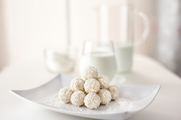 Chocolate candies in coconut pralines with milk