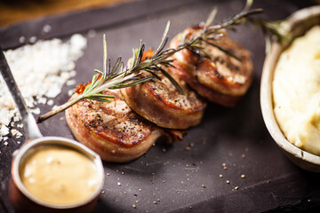 Pork tenderloin served on a board in restaurant