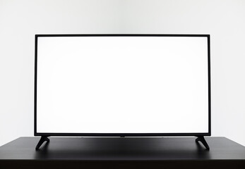 Smart TV mockup, Close up of LCD 4K television with blank screen standinding on TV stand.