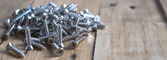 8mm and 1 inch size silver steel or metal screw on wooden top table - obrazy, fototapety, plakaty