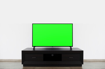 Smart TV mockup, Close up of LCD 4K television with blank screen standinding on TV stand.