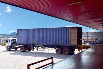 Truck align forty feet  container  to docking leveler to stuff cargo at distribution warehouse. Distribution, Logistics Import Export, Warehouse operation, Trading, Shipment, Delivery concept.