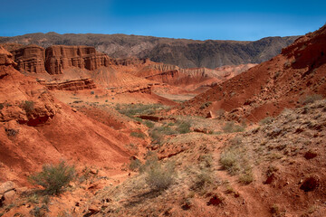Fototapeta na wymiar fantastic clay red castles in the sandy desert of the canyon Konorchek, in Kyrgyzstan 