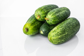 Composition of cucumber on a white background with reflection