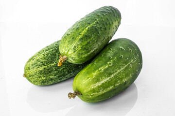 Composition of cucumber on a white background with reflection