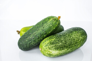 Composition of cucumber on a white background with reflection