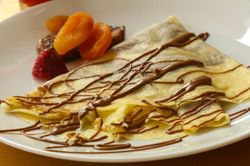 Pancake with chocolate and fruits