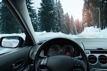 The car is driving on a winter road