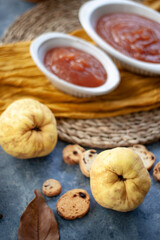 Quince Close up with a jelly quince in a white crockery containers and little toasts to spread.