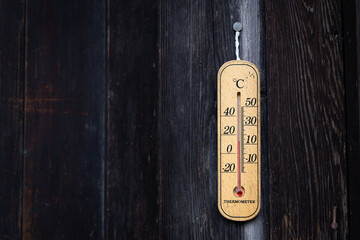 Wood thermometer on the wooden wall
