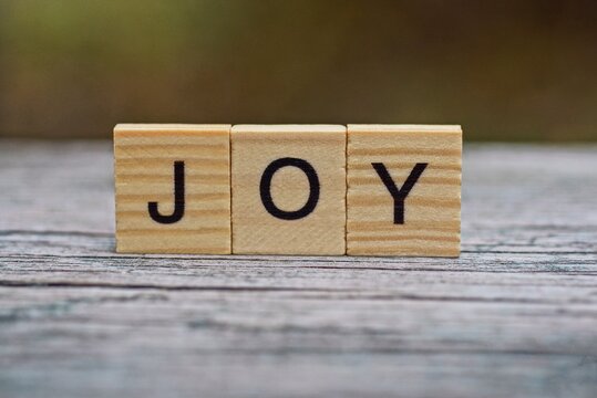 word joy of wooden letters on a gray table