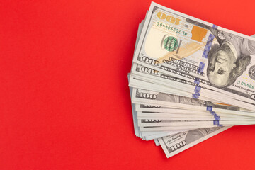 United States or US dollar currency on a red background. Money for christmas concept.