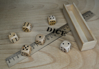 Six wooden dice, ruler, label on the wooden table.
