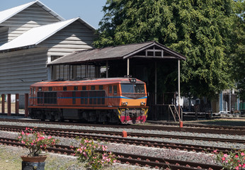 Fototapeta premium Old diesel electric locomotive is parking near the depot.