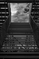 bleacher staircase in black and white. dark cloud