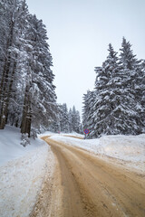 Dangerous slippery road through the mountains on a cold winter day