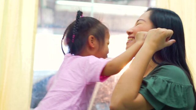 Happy loving family. Mother and her daughter child girl playing high five and hugging