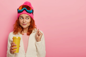 Ginger girl skier enjoys winter resort, has coffee break after reaching top of mountain, cheers...